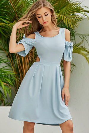 Light blue fit-and-flare dress with cold shoulder bow sleeves and open back detail.