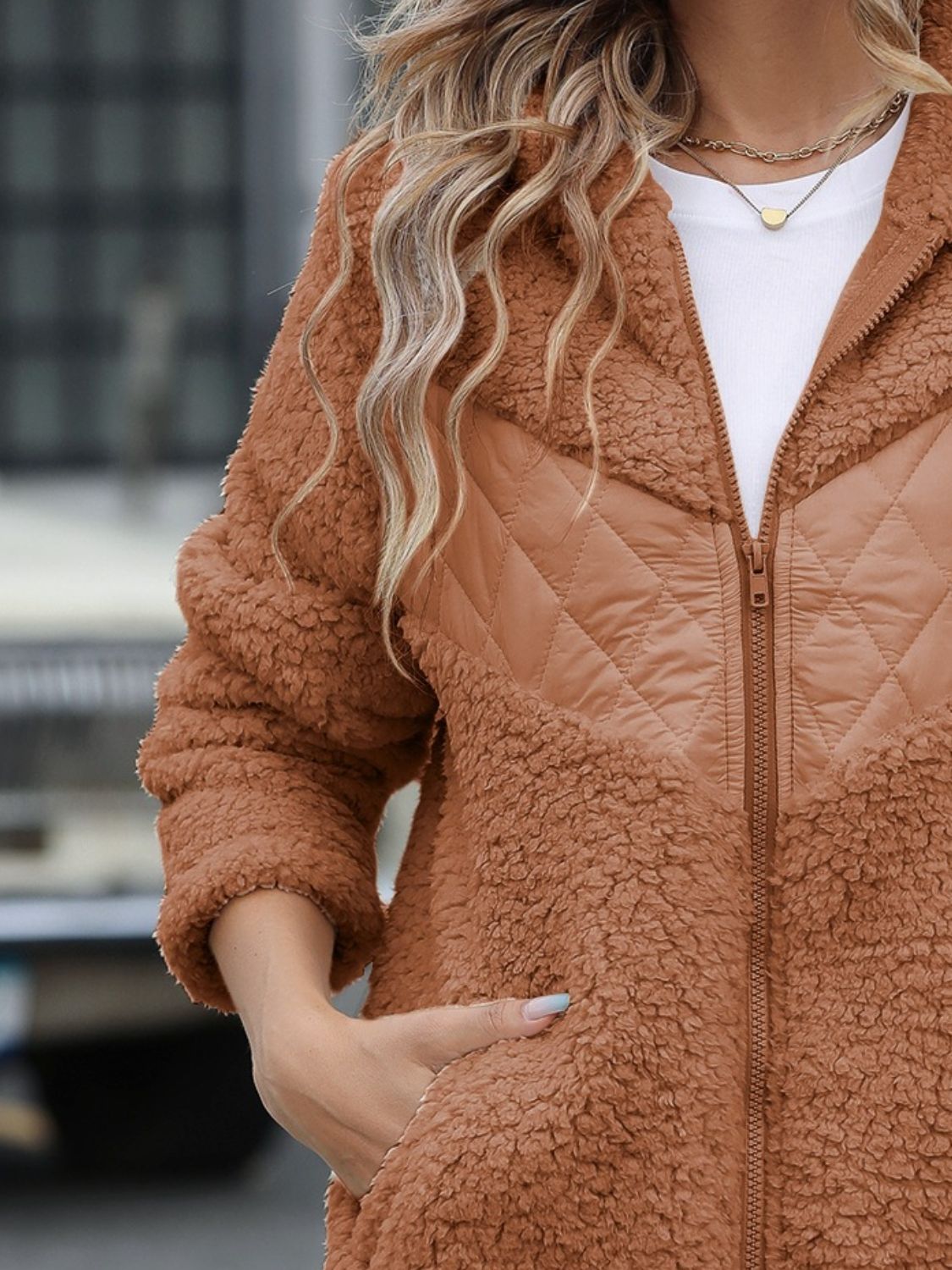 Caramel teddy hoodie with quilted panel detail and zipper closure.