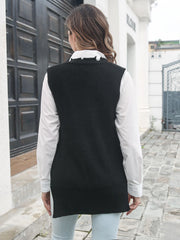 Black acrylic knit vest with asymmetric zip detail, worn over a white shirt.