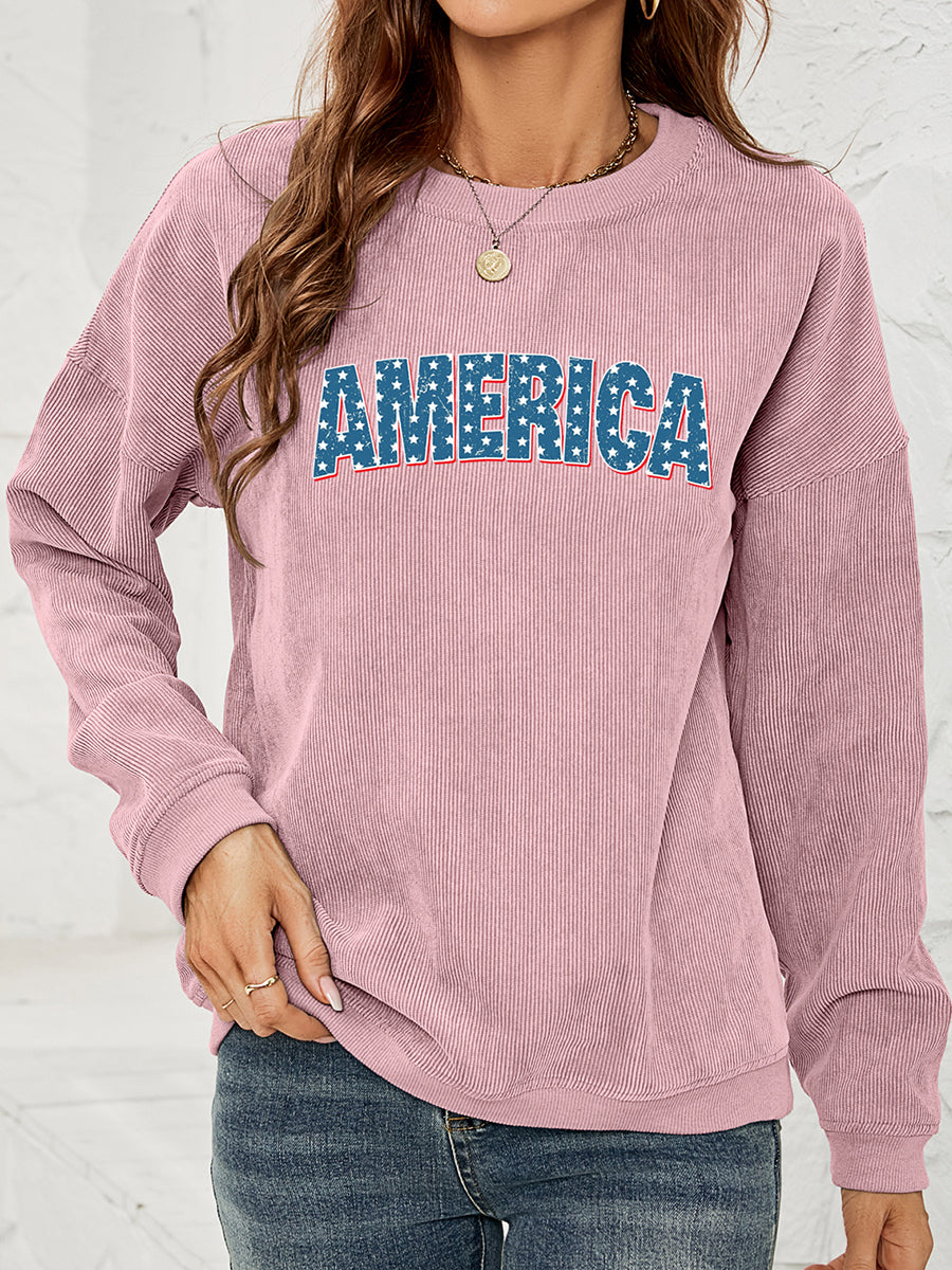 Dusty Pink corduroy sweatshirt with "AMERICA" graphic in star-spangled blue letters.
