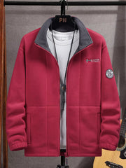 Men's red fleece zip-up jacket with grey collar and embroidered patch detail.