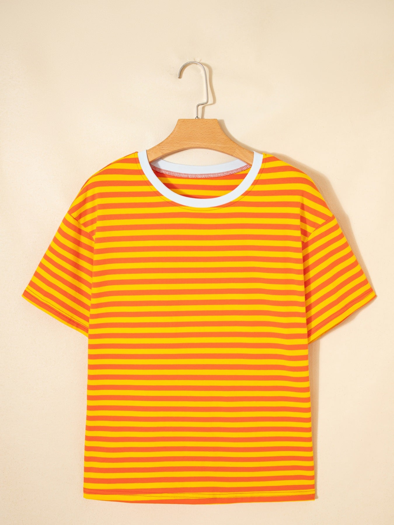 Striped round-neck cotton t-shirt in tangerine with a white neckline trim.