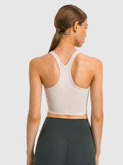 Beige sculpted racerback crop tank top with a v-neck detail.