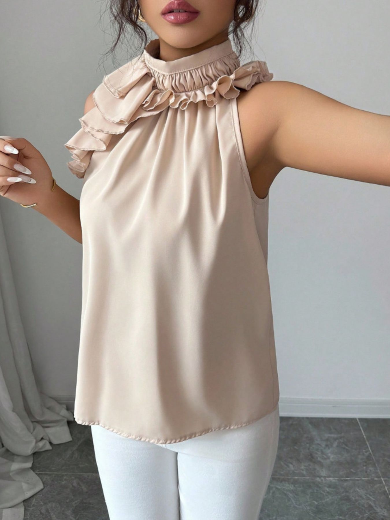 Ruffled high neck sleeveless blouse in red, black, apricot, or brown.