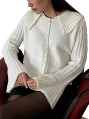 White acrylic cardigan with oversized collar and pearl buttons.