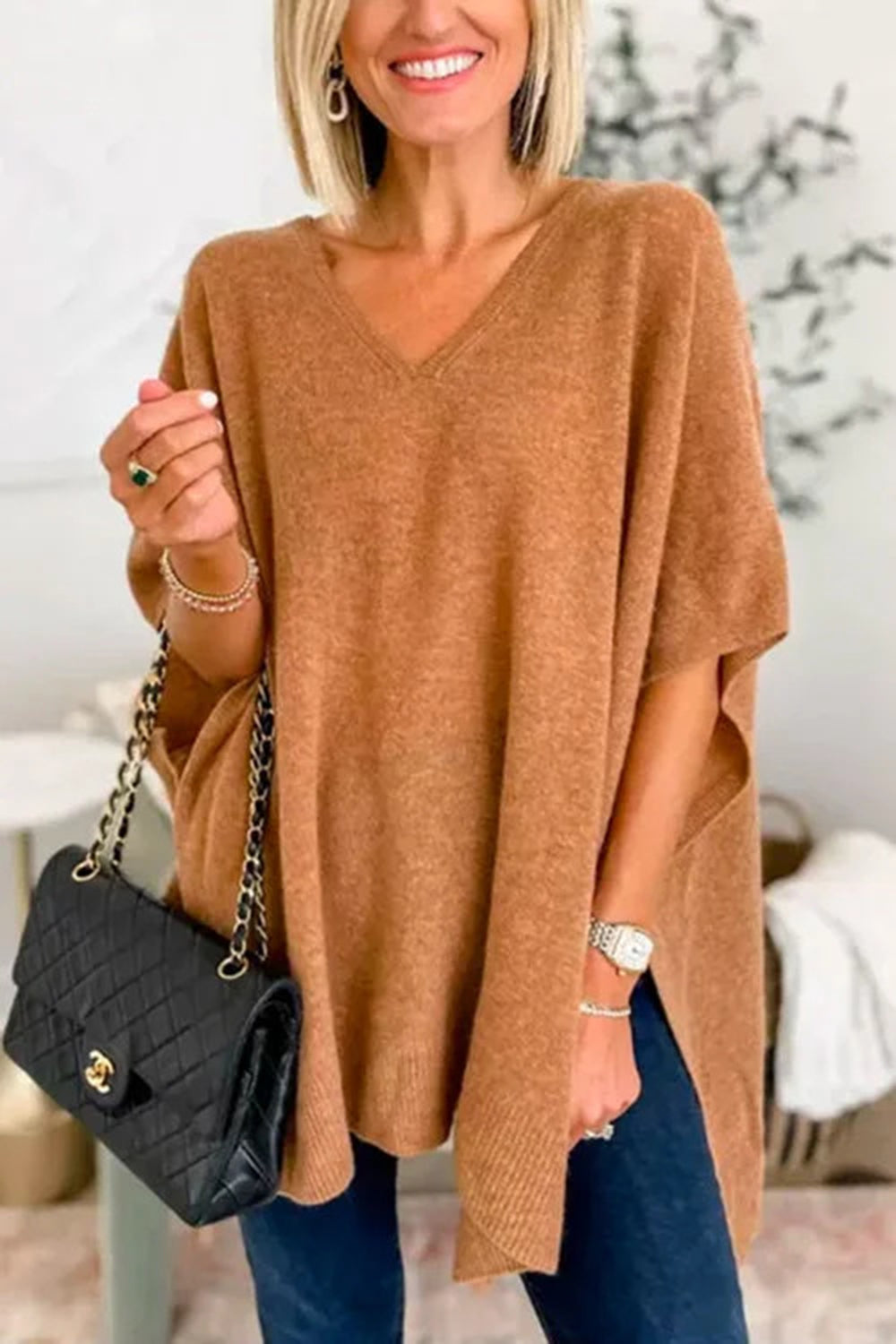 Relaxed V-neck knit poncho top in caramel with side slits and short sleeves.