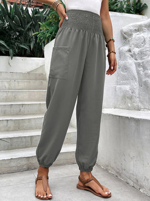 Gray relaxed-fit cargo pants with smocked waistline and elastic cuffs.