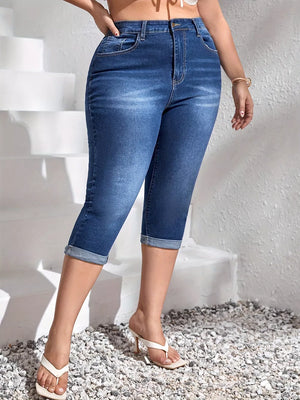 Flattering high waist dark blue denim capri jeans with cuffed hems.