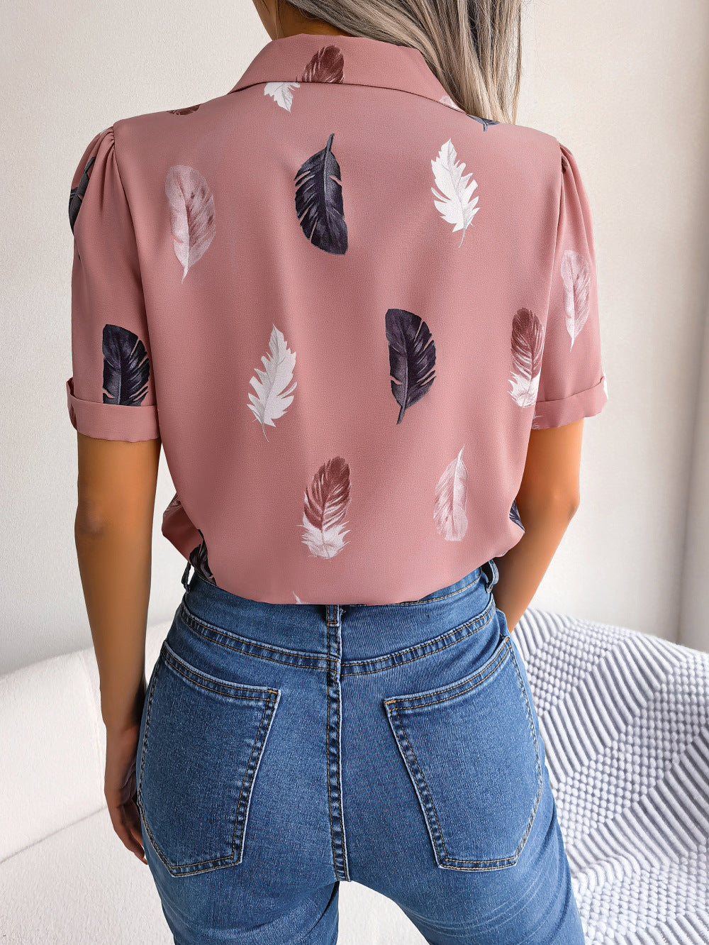 Dusty pink feather print collared puff sleeve blouse with rolled cuffs.