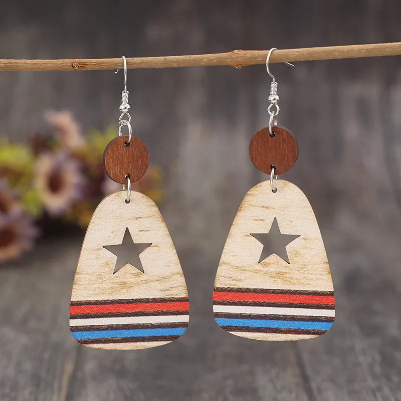 Star cutout wooden dangle earrings with red, white, and blue stripes.