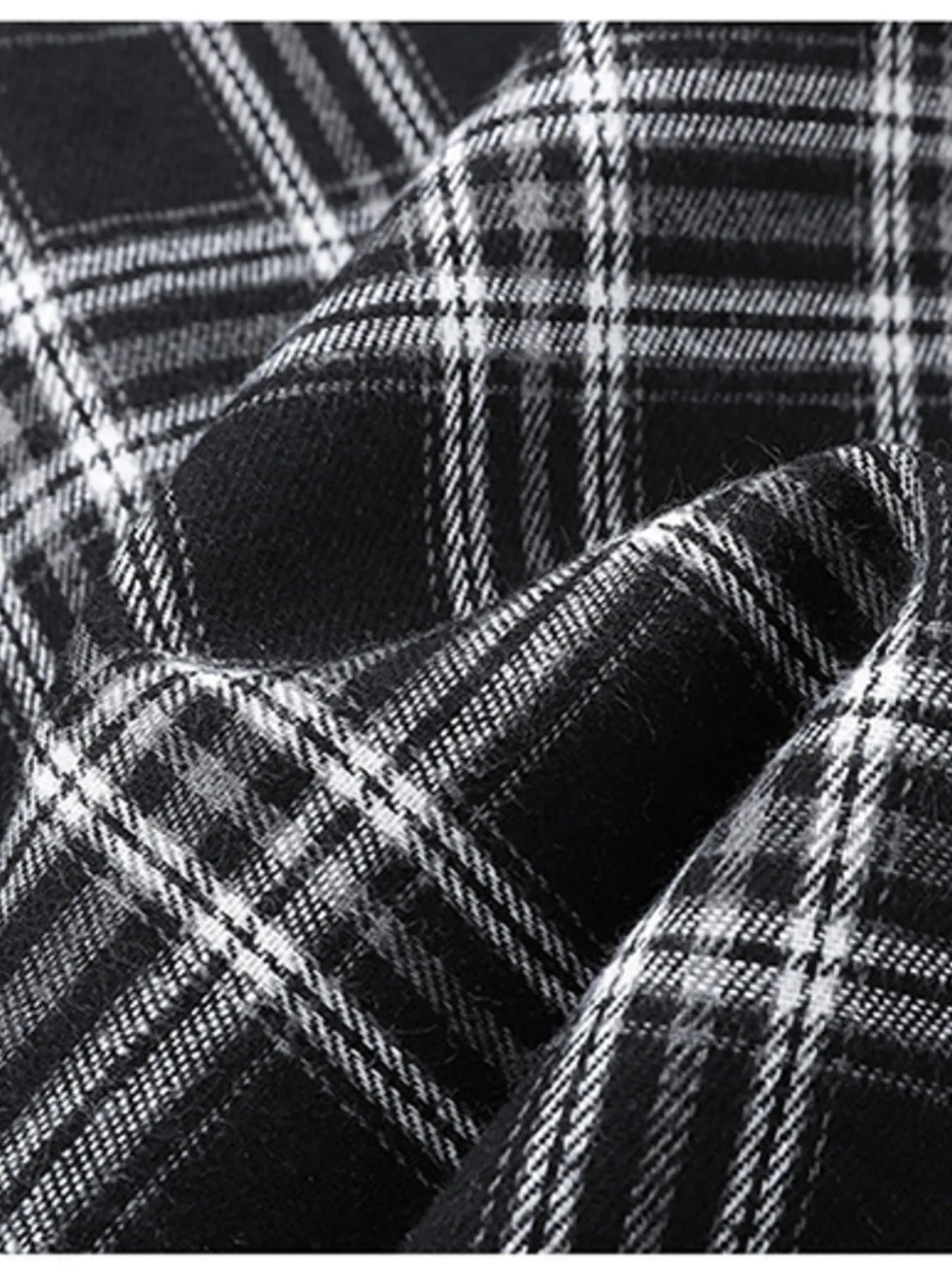 Men's black and white plaid button-up shirt detail, cotton blend fabric texture.