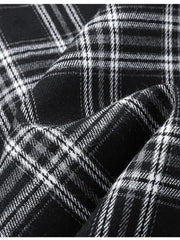 Men's black and white plaid button-up shirt detail, cotton blend fabric texture.
