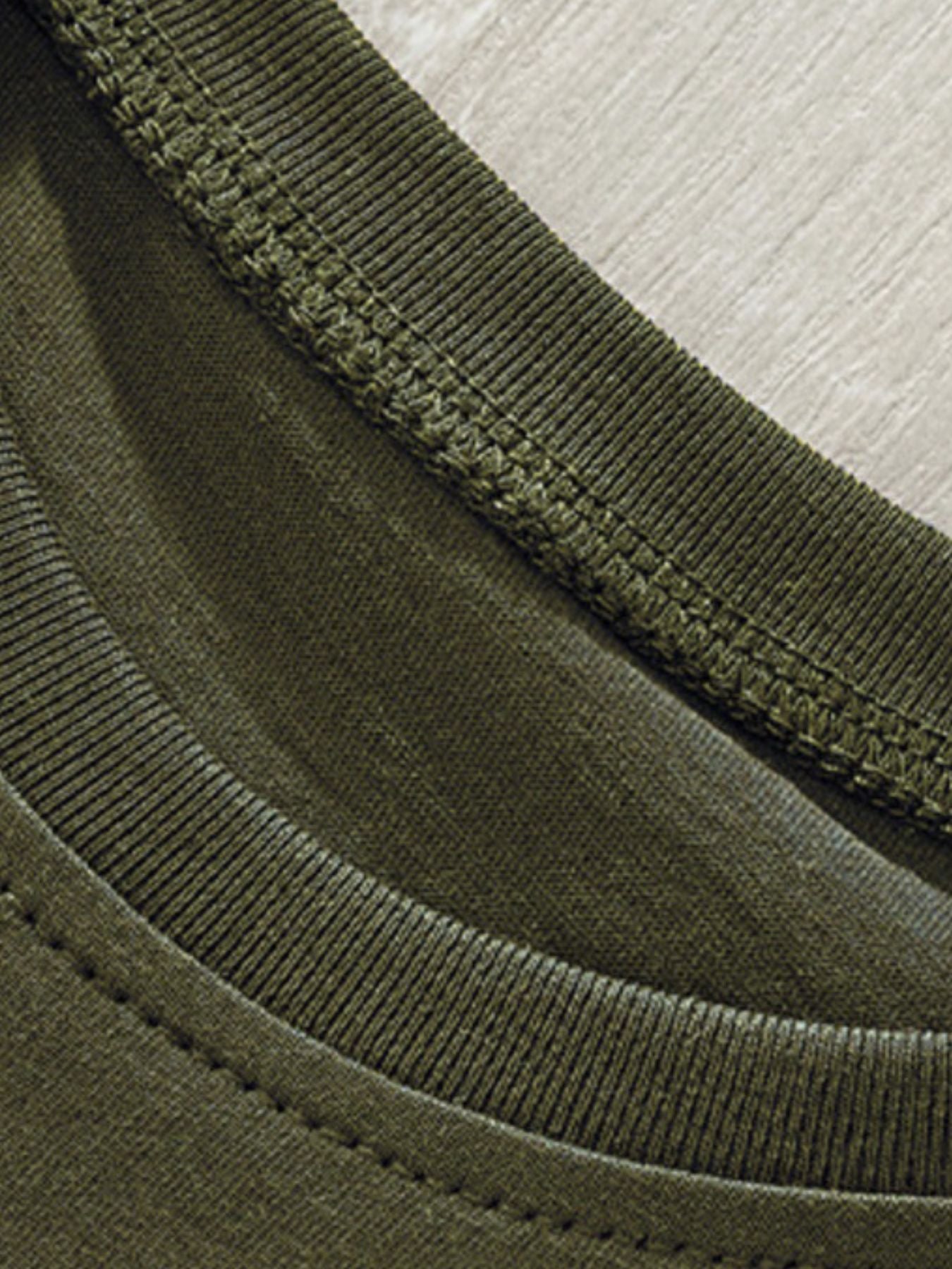 Toddler green crew neck t-shirt detail showing ribbed neckline and stitching.