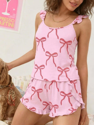 Pink cami and shorts set with red bow print and ruffled trim.