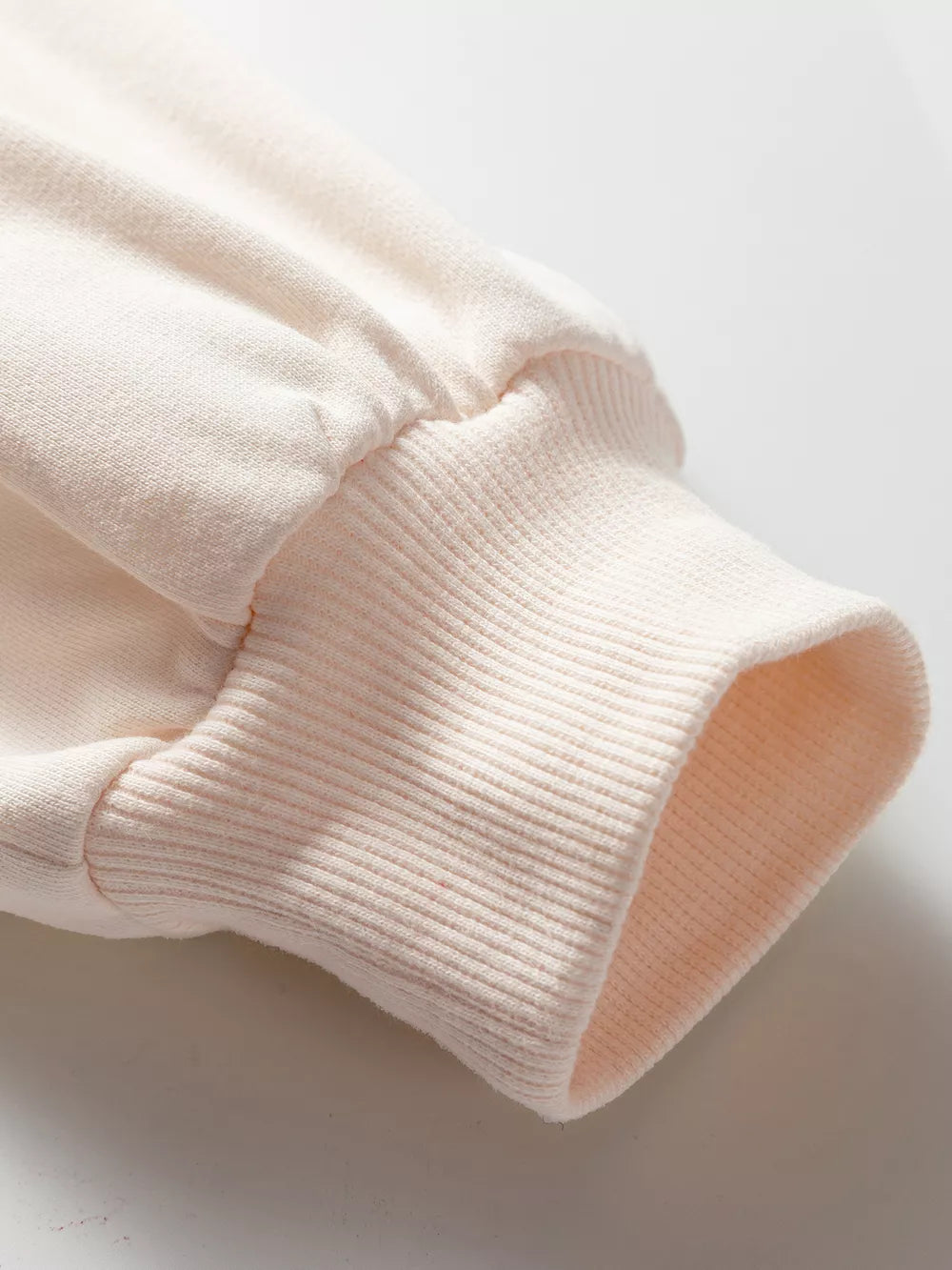 Oversized cotton sweatshirt cuff detail in light pink with ribbed texture