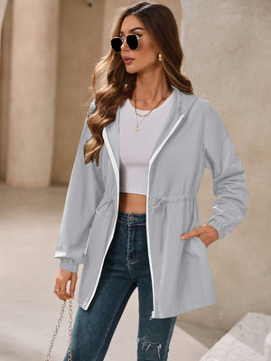 Gray hooded jacket with cinched waistline and white zipper detail