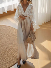 Elegant white lace crop top with deep V-neck and flowing sleeves paired with a beige linen maxi skirt.