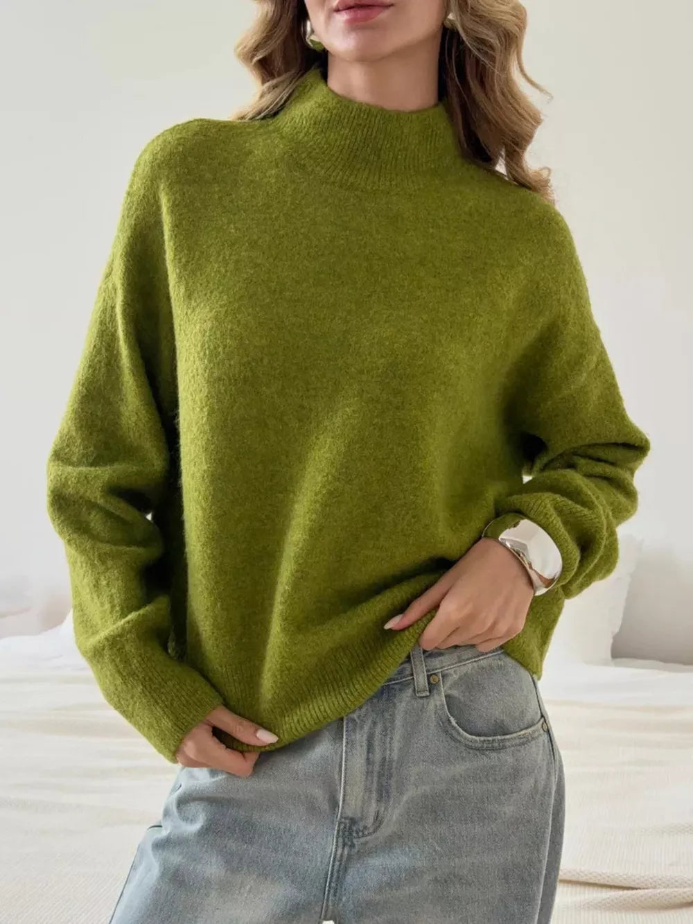 Relaxed mock neck knit sweater in moss green acrylic blend with long sleeves.