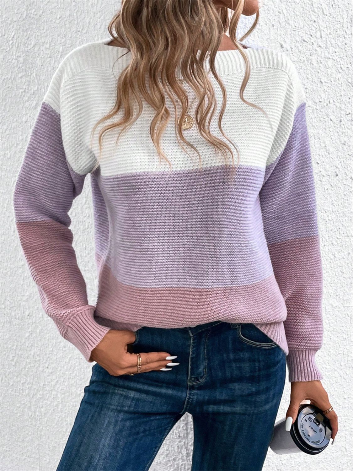 Colorblock boatneck knit sweater in white, lavender, and pink stripes.