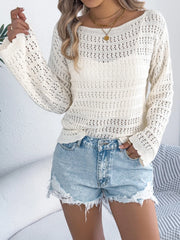 White openwork knit sweater with boatneck and bell sleeves, styled with denim shorts.