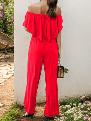 Red off-the-shoulder flounce jumpsuit with wide legs.