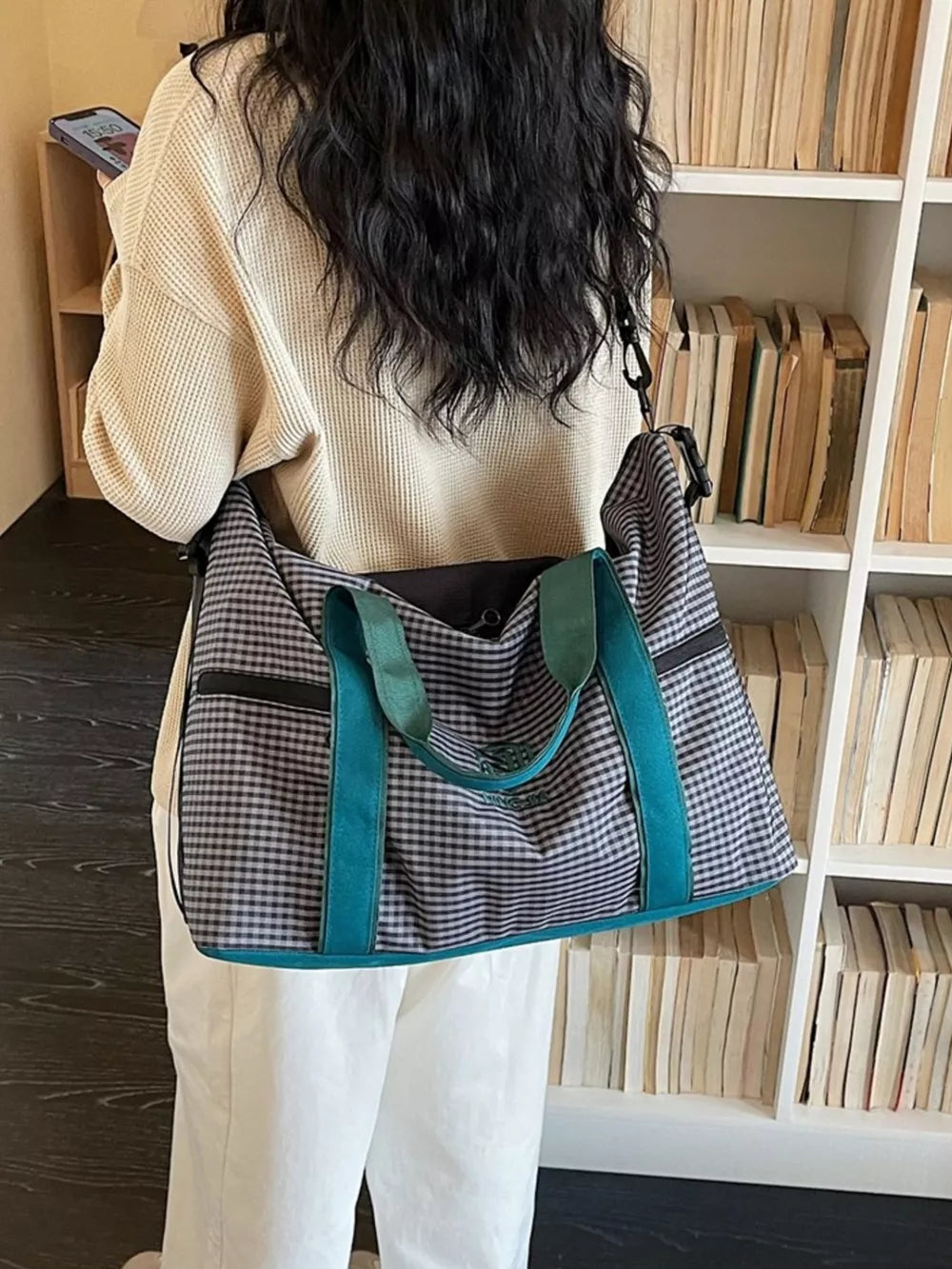 Large plaid travel bag with teal straps and handles