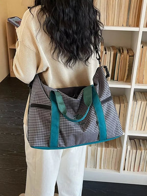 Large plaid travel bag with teal straps and handles