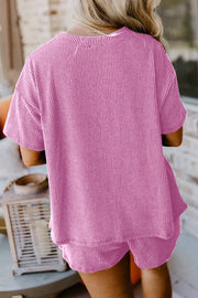 Pink waffle knit lounge set with short sleeves and a relaxed fit.