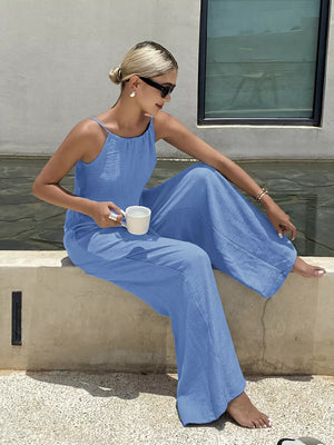 Blue tie-strap wide-leg maternity romper with a relaxed fit and flowing silhouette.