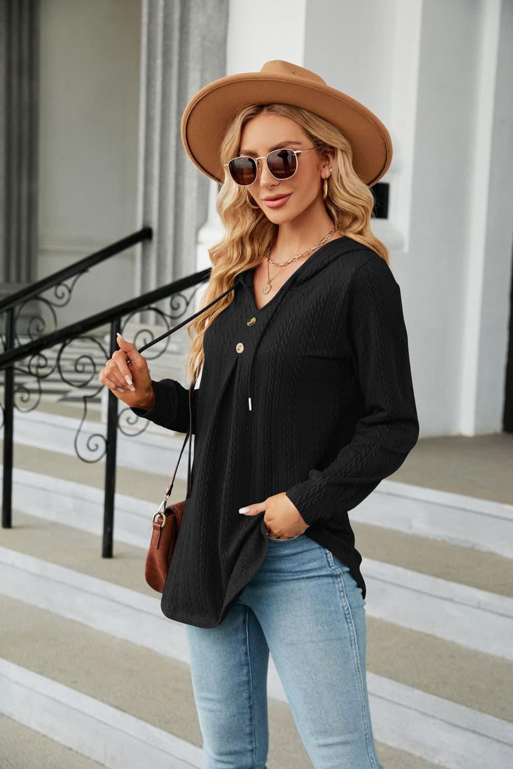 Black textured henley hooded tunic with drawstring and button detail, long sleeves.