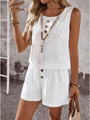 White cotton two-piece set with decorative buttons on top and shorts.