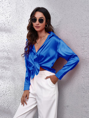 Royal blue silken button-down shirt with a knotted front detail.