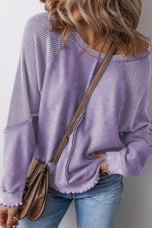Lavender waffle knit raglan sweatshirt with contrast sleeves and raw hem detail.