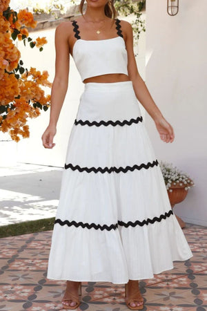 White crop top and tiered maxi skirt set with black scalloped trim.