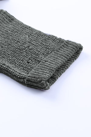 Distressed knit sweater in dark gray with a textured weave and ribbed cuff detail.