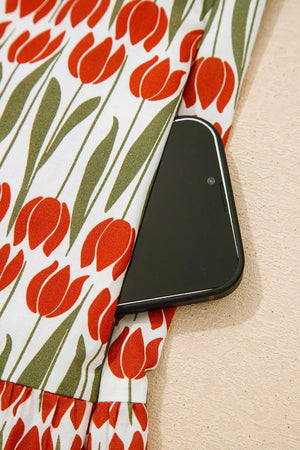 Cotton mini dress with red tulip print and side pocket detail.