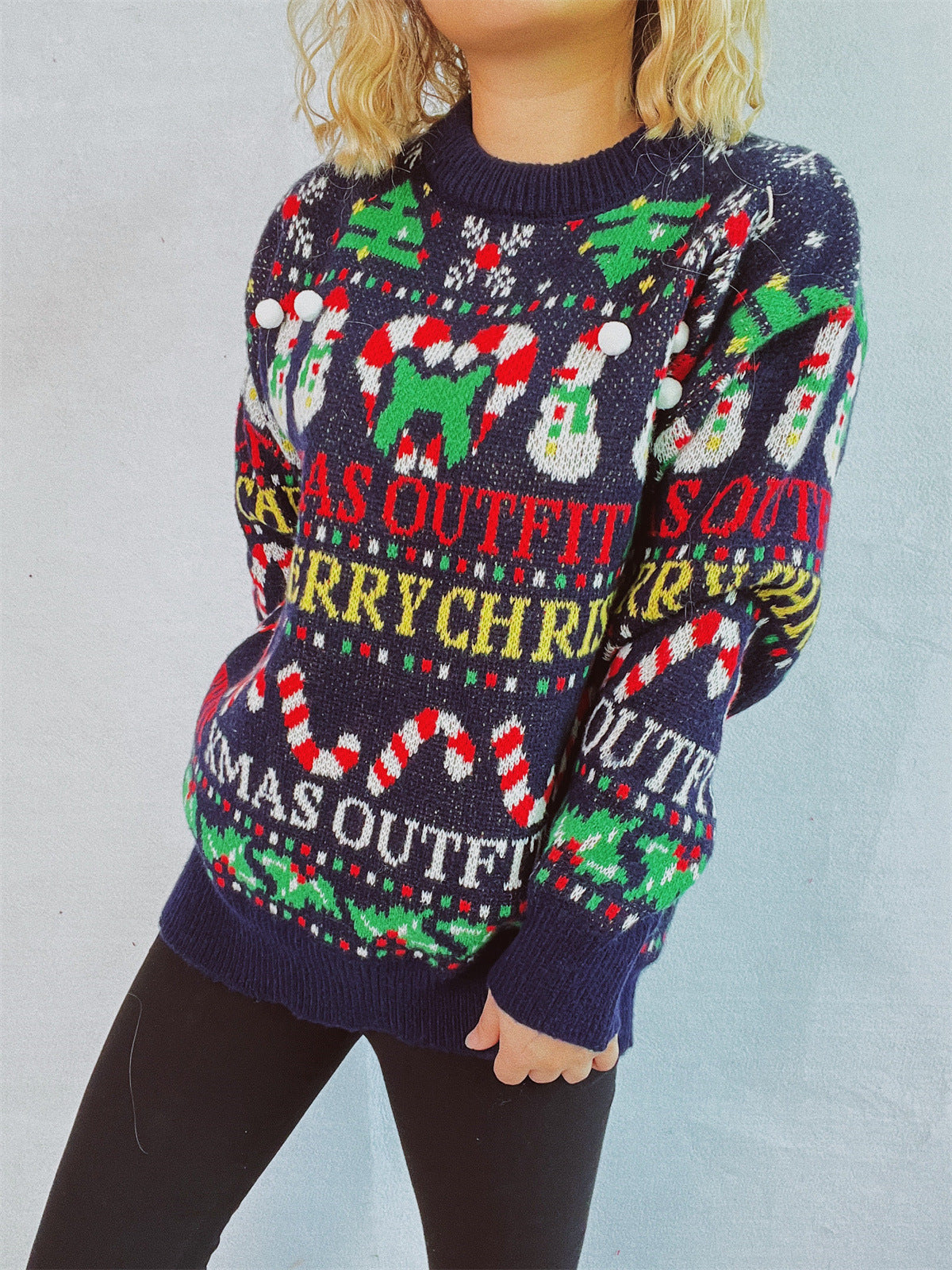 Dark blue graphic knit Christmas sweater with snowmen, candy canes, and trees.