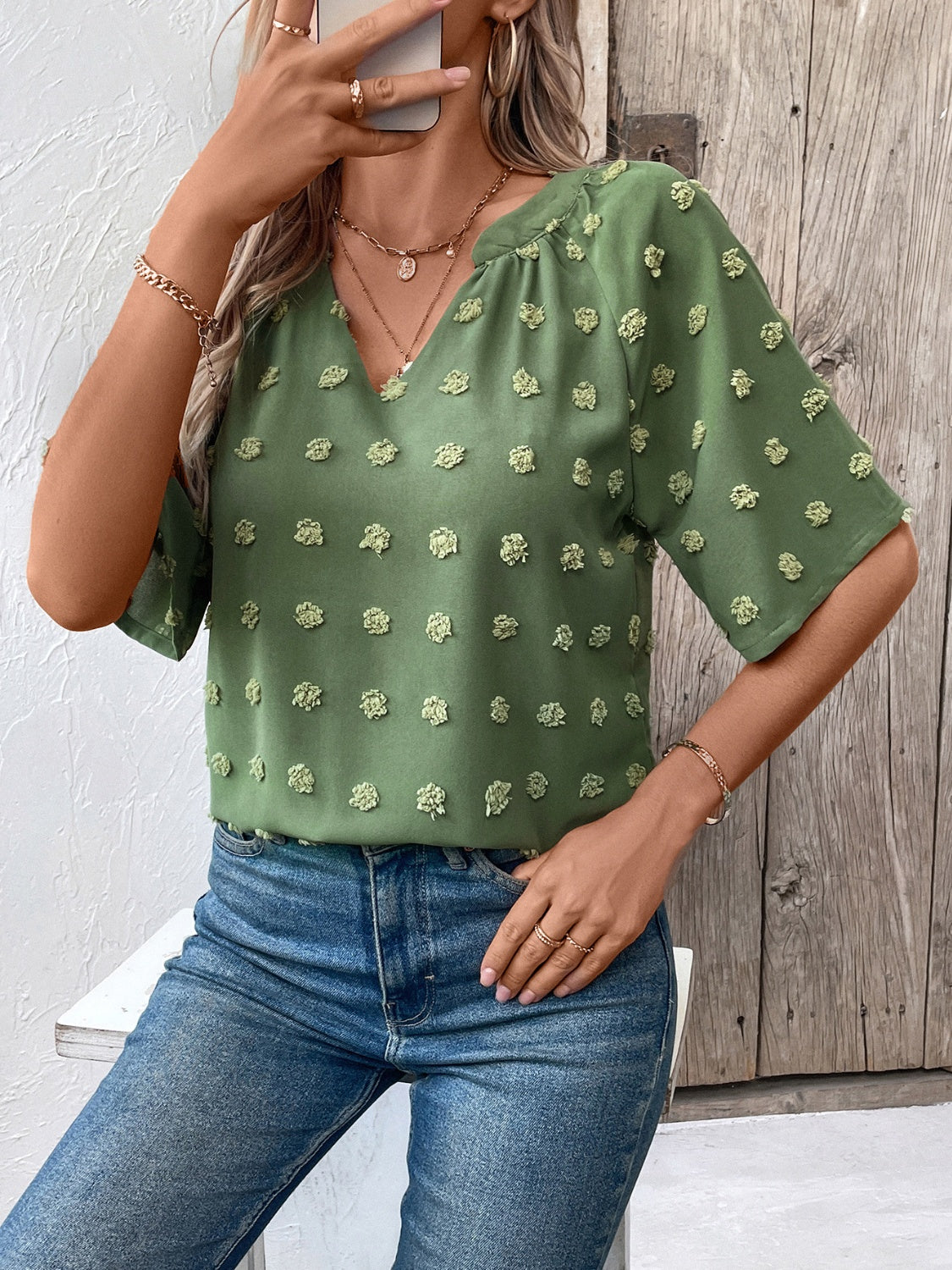 Moss green Swiss dot blouse with short sleeves and V-neckline, casual style.