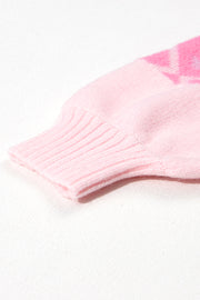 Pink acrylic knit sweater with geometric pattern and ribbed cuff detail.
