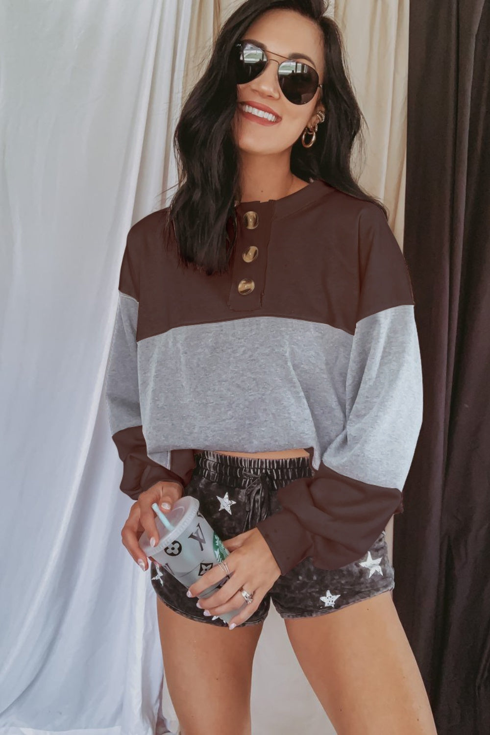 Colorblock henley sweatshirt in gray and dark brown with button detail and balloon sleeves.