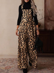 Leopard print wide leg romper with adjustable buckle straps and a black turtleneck underneath.