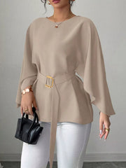 Khaki belted blouse with batwing sleeves and gold buckle detail.