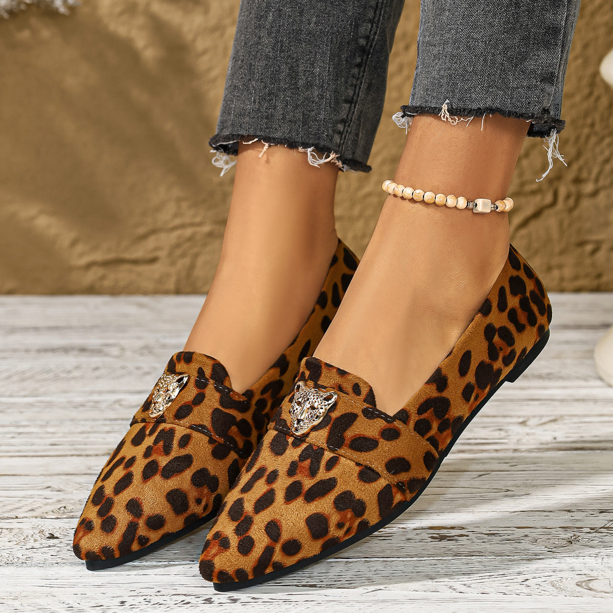 Point toe slip-on flats with leopard print and animal head embellishment