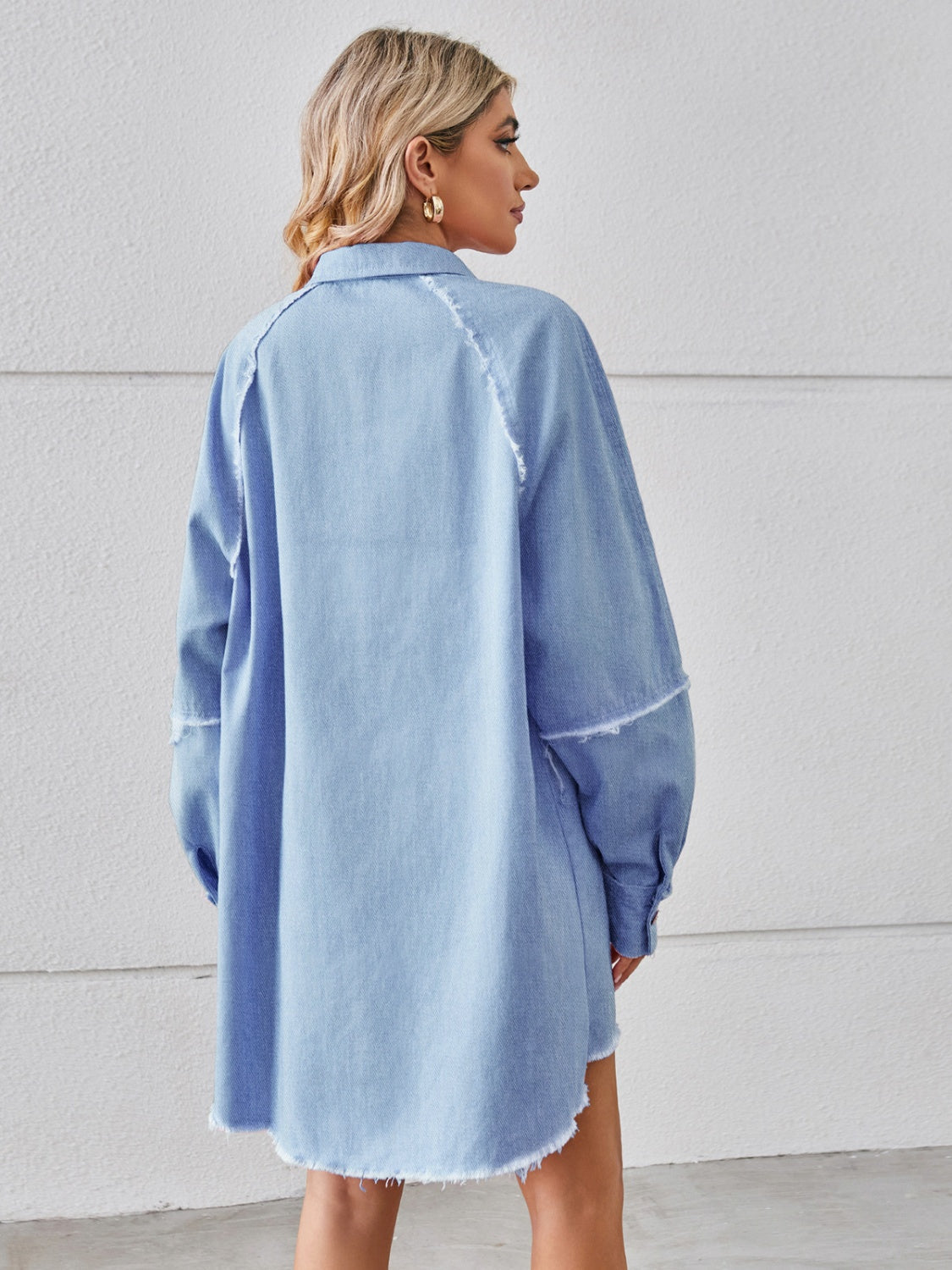 Light blue denim shirt dress with raw hem and button cuffs