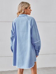 Light blue denim shirt dress with raw hem and button cuffs