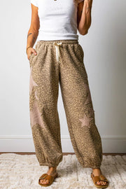 Leopard print relaxed fit pants with star patches and drawstring waist