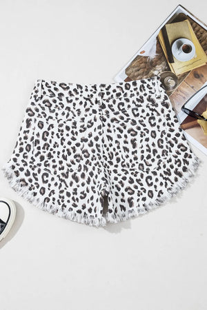 Leopard print denim shorts with frayed hem and a casual cut.