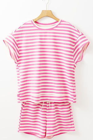 Blush pink and white striped loungewear set with a short sleeve top and drawstring shorts.