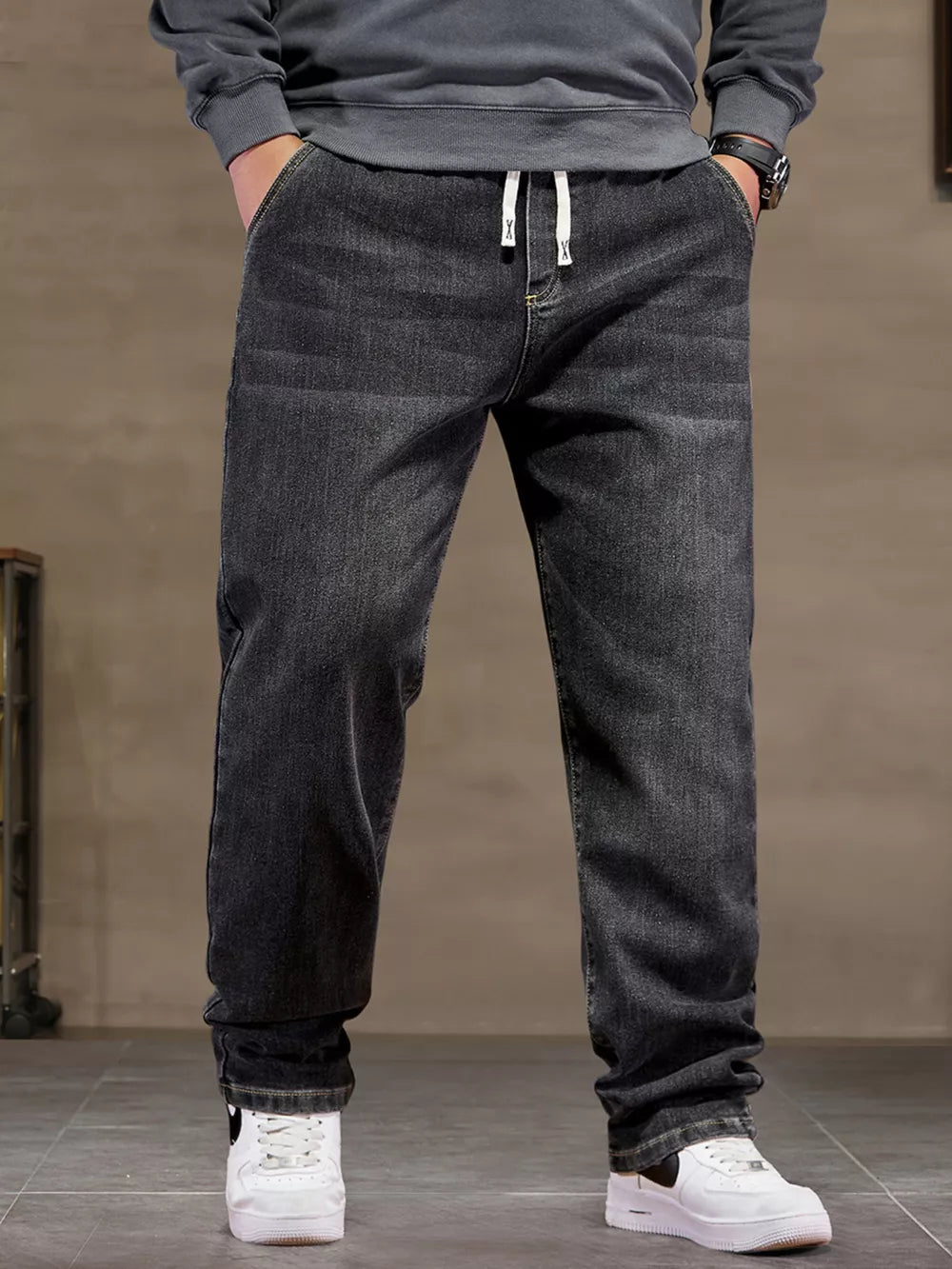 Black 100% cotton jeans with drawstring waist and relaxed fit.