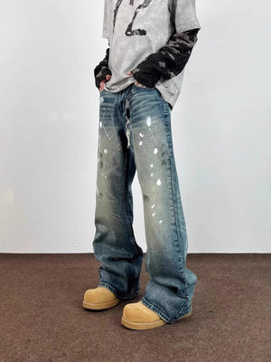 Men's blue 100% cotton wide leg jeans with paint splatters and distressed details.